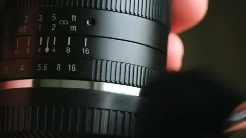 Photographer gently brushes surface of camera lens Stock-Footage 282643558