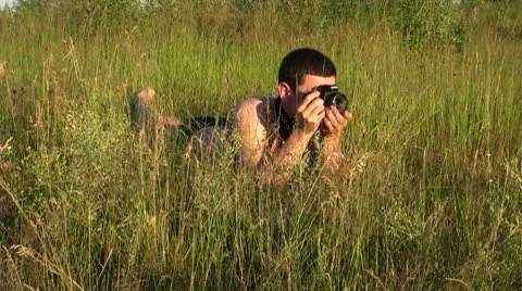 The photographer in the grass. Stock Footage 8853354