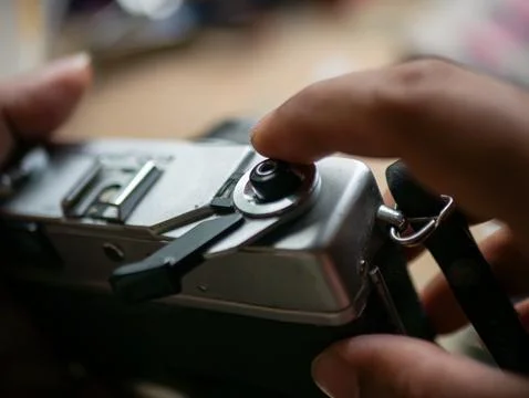 Photographer Hand Pressing Shutter Button on Vintage Film Camera Taking Pic.. 库存照片