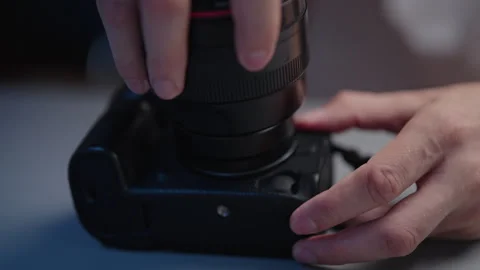 Photographer hands assembling dslr camera lens after comprehensive cleaning and Stock Footage 319771625