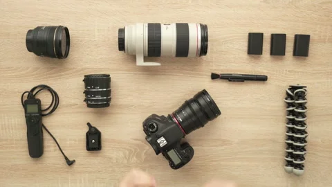 Photographer hands changing lens on camera, changing battery Stock Footage 91935880