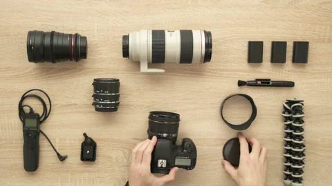 Photographer hands put filter on camera lens, clean camera and change battery Stock Footage 91935746