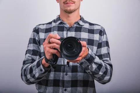 A photographer is holding a reflex camera, studio photo, half face of the p.. Stock Photos