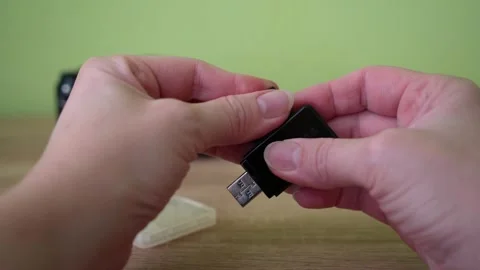 Photographer Inserting Memory Card into Reader for Data Transfer Video stock 332794930