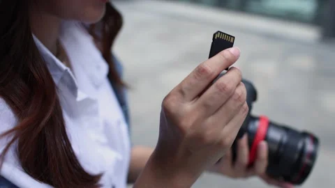 Photographer Installing SD Card Into Camera Outdoors Stock Footage 341661096