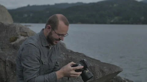 Photographer looking at the back of his camera Stock Footage 44351010