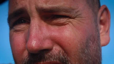 Photographer looking into camera lens changing focus and lighting for Stock Footage 219940406