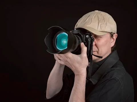 Photographer looking through camera Stock Photos