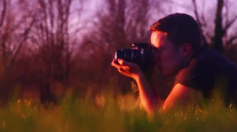 Photographer lying in the grass Stock Footage 48896982