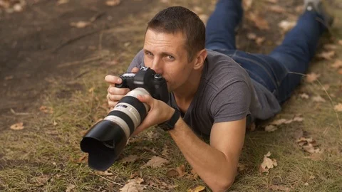 Photographer lying on the ground Video stock 125171865