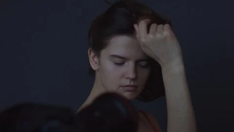 Photographer man adjusting models position while photoshoot in black studio  Stock Footage 104736676