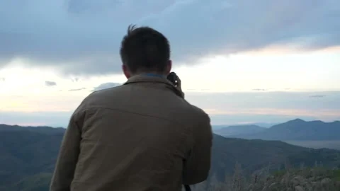 Photographer on a mountain top Stock Footage 146239645