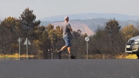 PHOTOGRAPHER IS MOVING TO SHOOT A MOUNTAIN AFTER FOREST FIRE IN SLOW MOTION Stock Footage 209141153