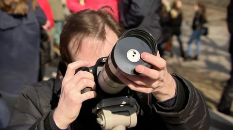Photographer photographing a solar eclipse through the disk Stock Footage 48217321