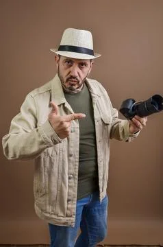 Photographer pointing at camera with stern expression Stock Photos
