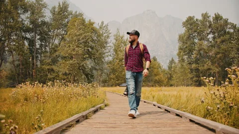 Photographer with professional camera set walking through autumn Yosemite Park Stock Footage 138283363