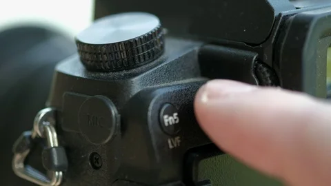 Photographer pushes flash button on camera Stock Footage 116964294