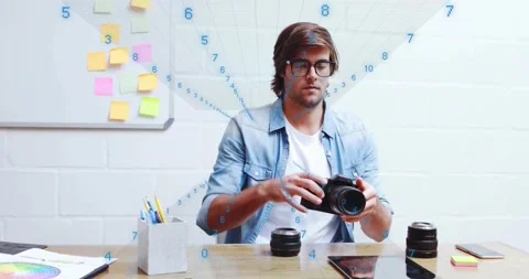 Photographer reaching for DSLR camera, switching lenses and tapping tablet for Stock Footage 320287539