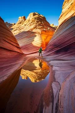 Photographer Reflected in Puddle while exploring The Wave Stock Photos