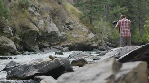 Photographer on the river Stock Footage 54709039
