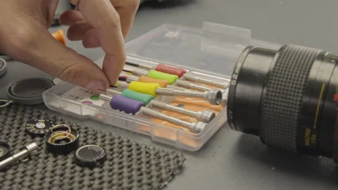 Photographer Selecting Specialized Tools for Camera Repair Video stock 303504235