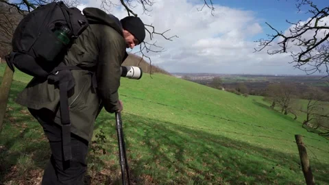 A photographer setting up a camera and tripod for a picture of Birmingham 動画素材 240659042