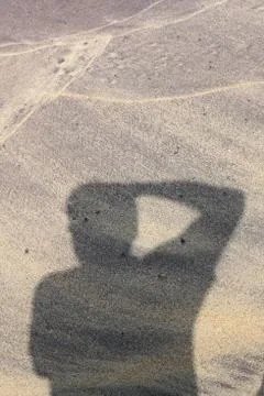 Photographer shadow on beach Foto stock