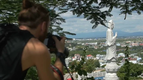 Photographer shoot at the camera a large statue of a tall white Buddha Video stock 73566786