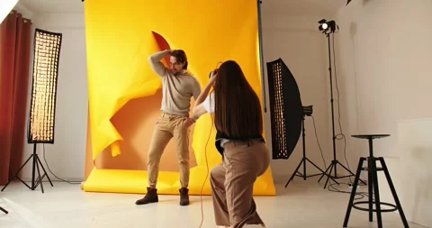 Photographer shooting model in studio with softboxes Stock Footage 279915201