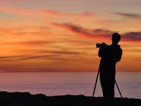 Photographer shooting the sunset Stock Photos