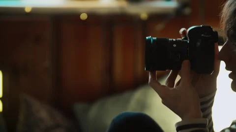 The photographer shoots while looking through the camera viewfinder. Creative Stock Footage 264063968