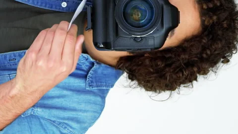Photographer showing visiting card while taking photo with digital camera Vidéo 300830133