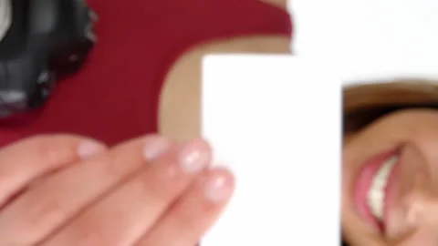 Photographer showing visiting card while taking photo with digital camera Vidéo 300830224