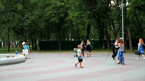 Photographer strolling through the park Stock Footage 11357891