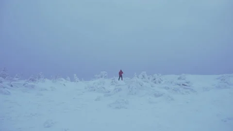 Photographer through the Snowstorm Stock Footage 130744880