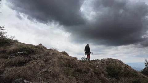 Photographer on top of the mountain exploring the landscape Stock Footage 192833893