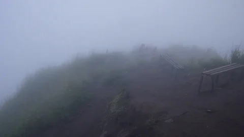 Photographer on top of a volcano in the dense clouds Video stock 128001885