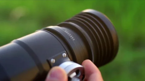 Photographer using a camera to take photo, adjudting the lense Stock Footage 82147527