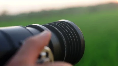 Photographer using a camera to take a photo, adjudting the lense. Video stock 82147538