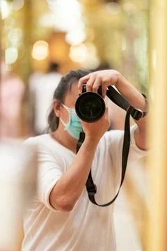 Photographer using camera to taking Self Portrait in the mirror.Photographe.. Stock Photos