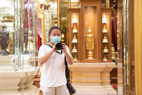 Photographer using camera to taking Self Portrait in the mirror.Photographe.. Stock Photos