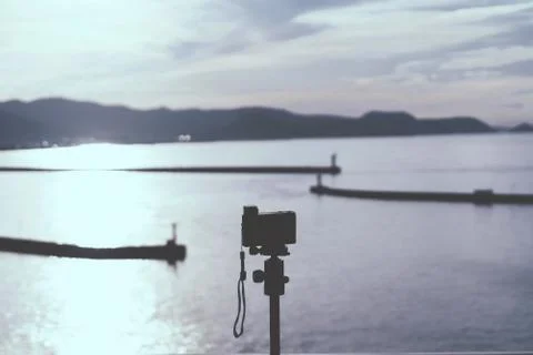 Photographer using Compact Camera to shoot sunset on Japan Island 库存照片