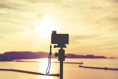 Photographer using Compact Camera to shoot sunset on Japan Island Stock Photos