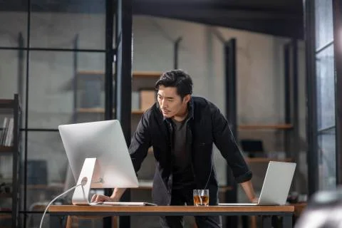 Photographer using computer in studio Stock Photos