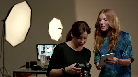 Photographer using digital tablet and SLR camera at studio. Stock Footage 64016389