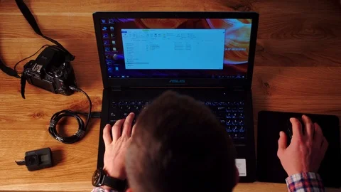 Photographer using Dslr camera and laptop to download his files to the computer. Stock Footage 116124845