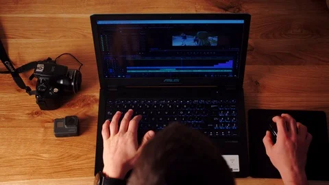Photographer using Dslr camera and laptop to download his files to the computer. Stock Footage 116125816