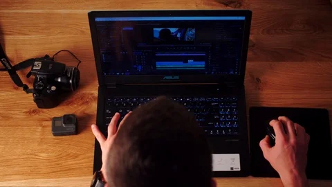 Photographer using Dslr camera and laptop to download his files to the computer. Stock Footage 116127295