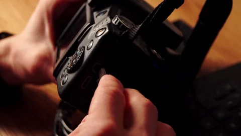 Photographer using Dslr camera and laptop to download his files to the computer. Stock Footage 116128654