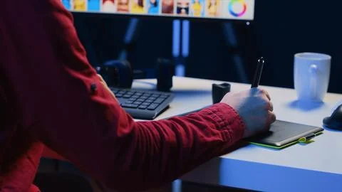 Photographer using graphic tablet to perform editing operations to correct Stock Photos